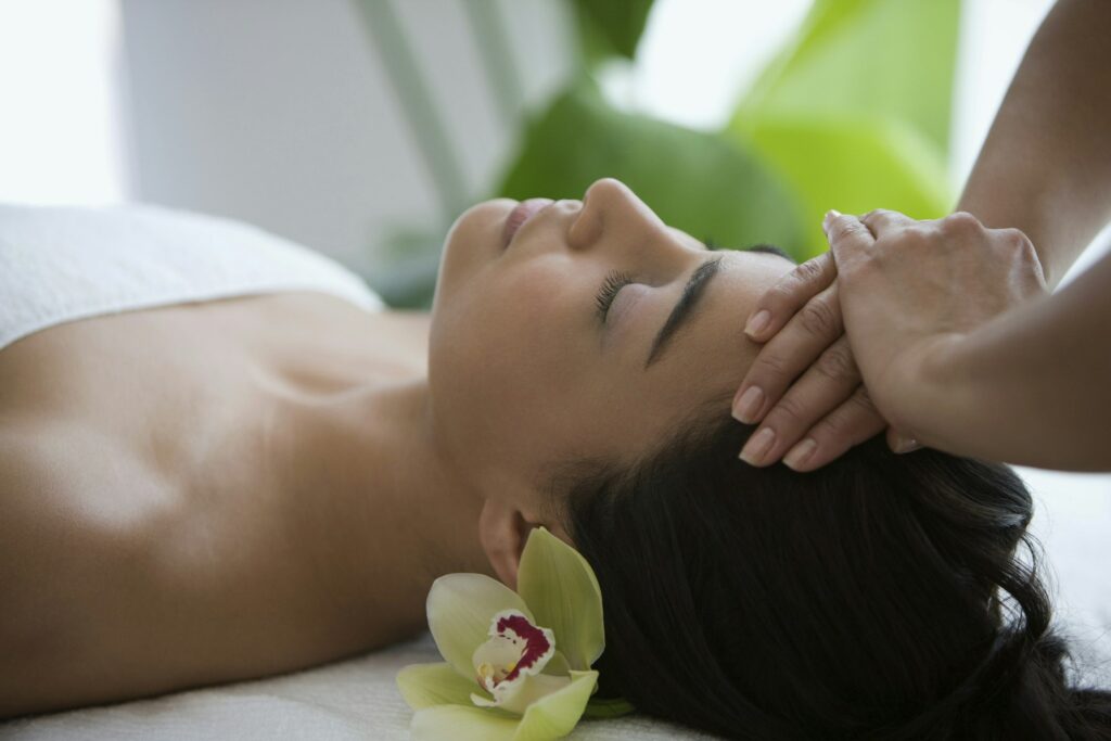 Woman enjoying a relaxing head massage at a spa